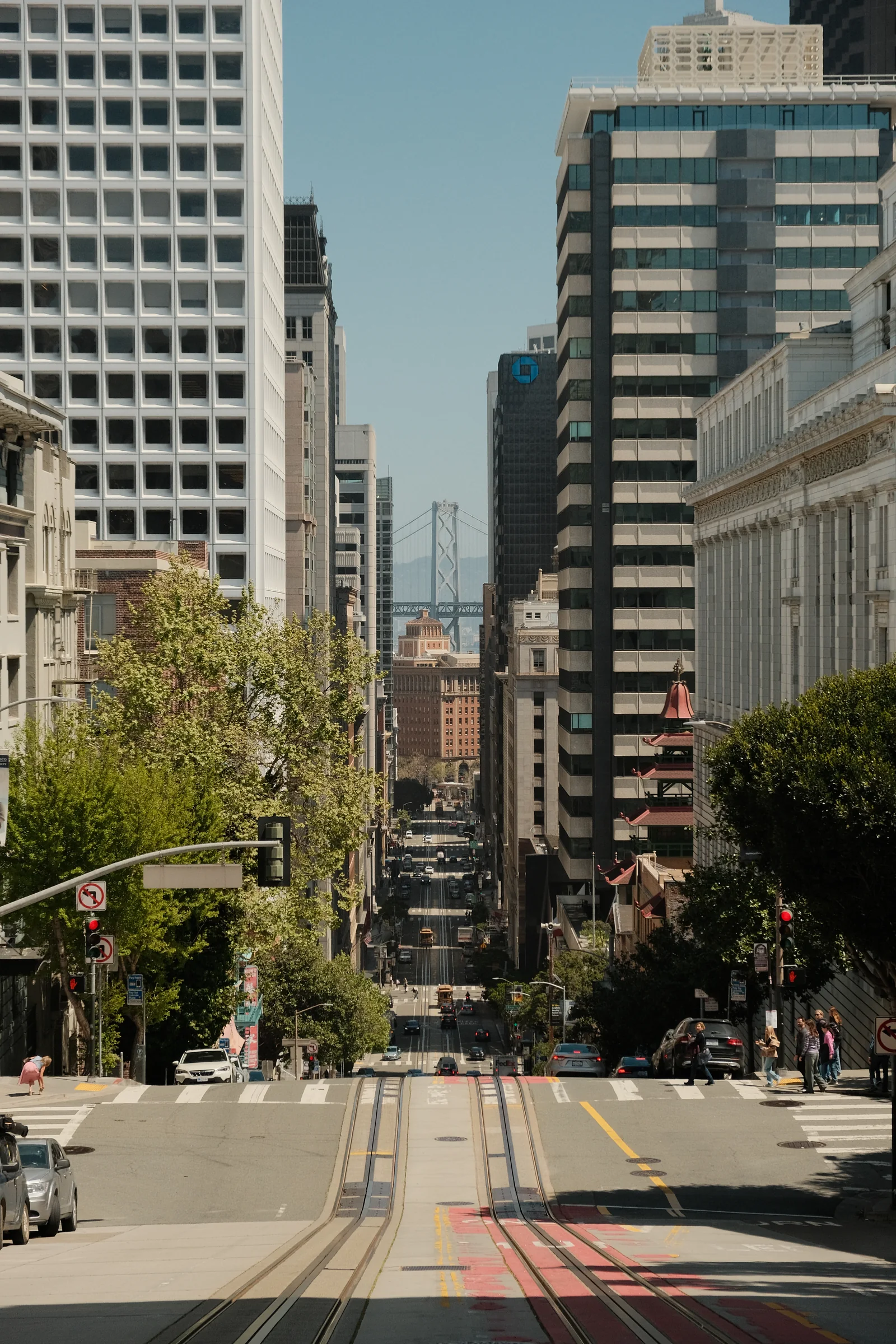 Sunlit downtown street framed by tall buildings